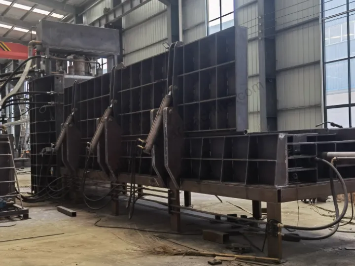 the unpainted steel support base and side hydraulic cylinders of a gantry shear's silo